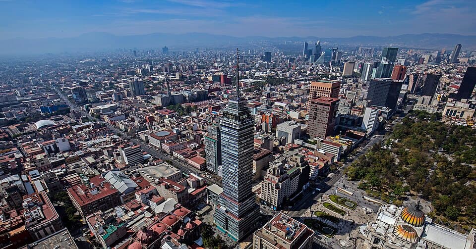 Aerial view across central Mexico City with the Palacio de Bellas Artes dome in the foreground